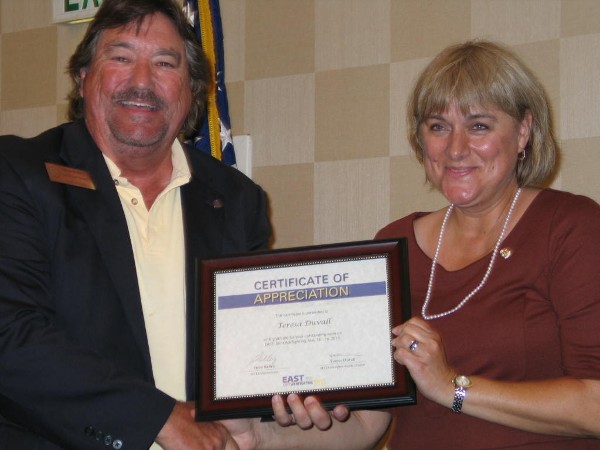 Steve Kelley, regional vice president, presents Duvall with a certificate of appreciation for her accomplished tenure as chapter president and for her coordination of the EAST Joint Warfighting 2013 Cyber Engagement Theater.